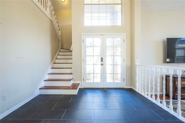 doorway to outside featuring a high ceiling and french doors