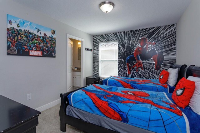 5295 Wildwood Way, Davenport, FL 33837 - carpeted bedroom featuring an accent wall, baseboards, and connected bathroom