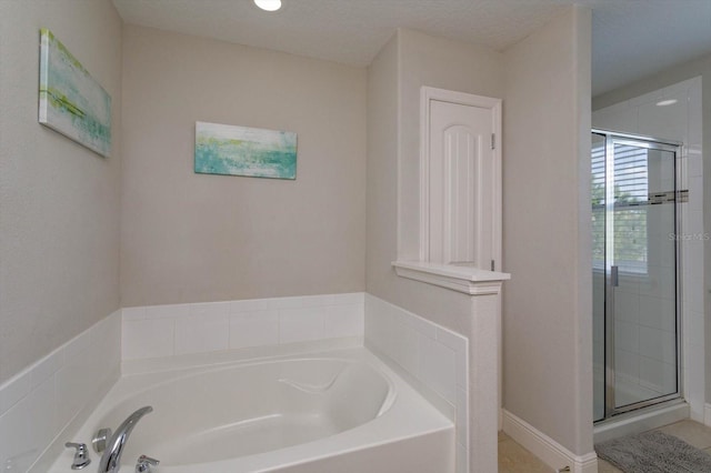 5295 Wildwood Way, Davenport, FL 33837 - bathroom featuring a garden tub and a shower stall