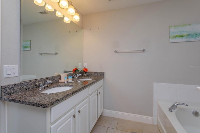5295 Wildwood Way, Davenport, FL 33837 - bathroom with tile patterned floors, a garden tub, double vanity, and baseboards