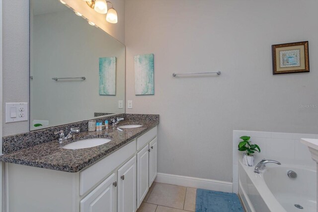 5295 Wildwood Way, Davenport, FL 33837 - full bath with tile patterned floors, a garden tub, double vanity, and baseboards