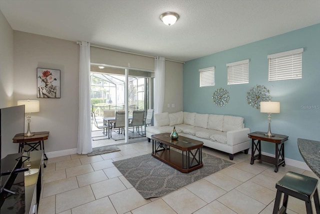 5295 Wildwood Way, Davenport, FL 33837 - living room with light tile patterned floors and baseboards