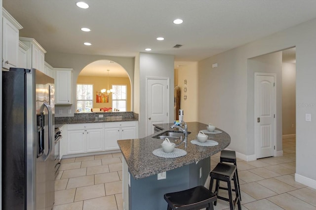 5295 Wildwood Way, Davenport, FL 33837 - kitchen featuring stainless steel refrigerator with ice dispenser, a sink, a chandelier, arched walkways, and light tile patterned flooring