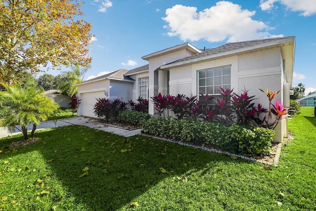 view of front of house featuring a garage and a front yard