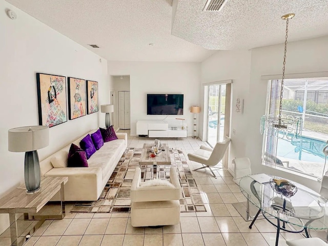 tiled living room featuring a textured ceiling and vaulted ceiling