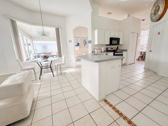 kitchen with pendant lighting, stainless steel range with electric cooktop, sink, a healthy amount of sunlight, and white cabinetry