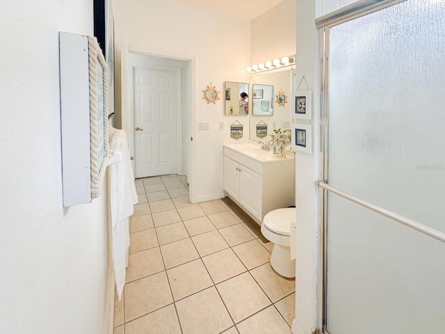 bathroom with tile patterned flooring, vanity, an enclosed shower, and toilet