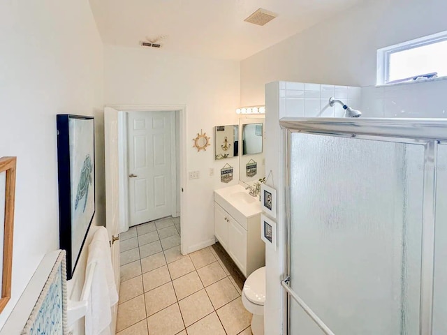 bathroom with tile patterned floors, vanity, toilet, and a shower with shower door