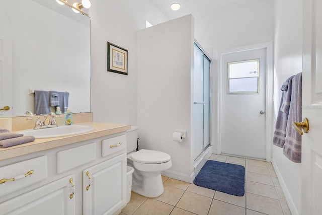 bathroom with tile patterned floors, vanity, an enclosed shower, and toilet