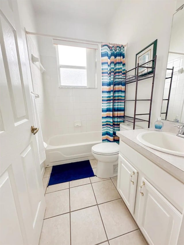 full bathroom with tile patterned flooring, vanity, shower / tub combo with curtain, and toilet