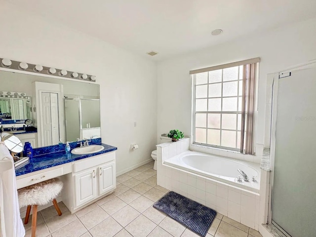 full bathroom featuring tile patterned floors, separate shower and tub, vanity, and toilet