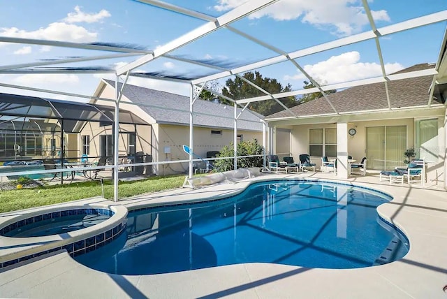 view of swimming pool featuring glass enclosure, an in ground hot tub, and a patio area