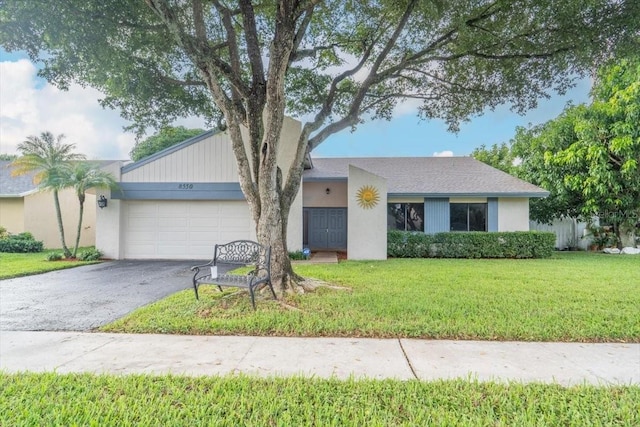 ranch-style house with a front yard and a garage