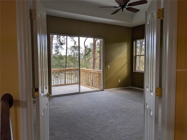 empty room featuring carpet, ceiling fan, and baseboards