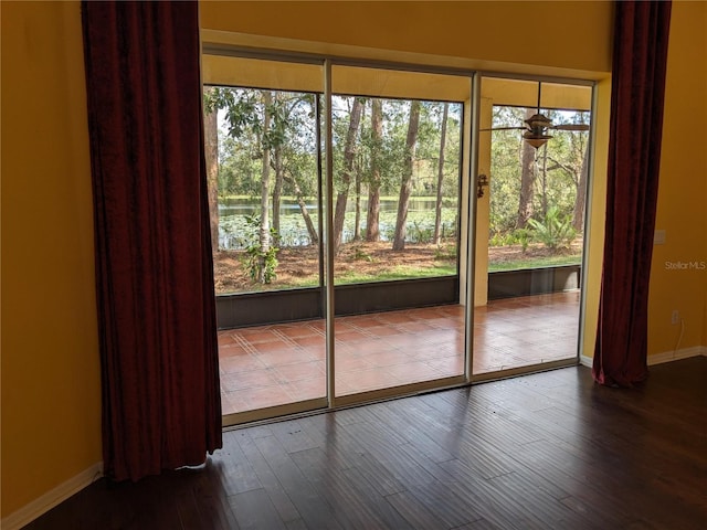 entryway featuring baseboards and wood finished floors