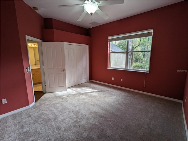 unfurnished bedroom featuring carpet, a closet, ceiling fan, and baseboards