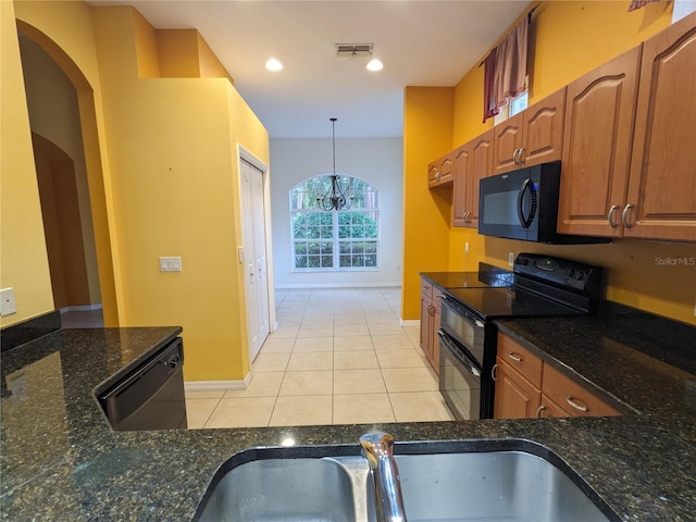 kitchen with visible vents, brown cabinets, decorative light fixtures, black appliances, and light tile patterned flooring