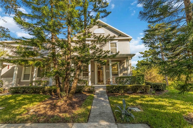 view of front of property featuring a porch and a front lawn