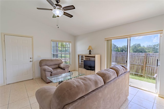 living area featuring ceiling fan, light tile patterned flooring, and vaulted ceiling