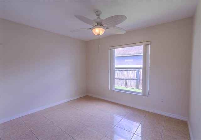 unfurnished room with light tile patterned flooring, ceiling fan, and baseboards