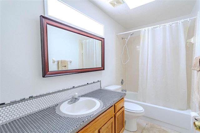 bathroom featuring vanity, toilet, visible vents, tile patterned flooring, and shower / tub combo with curtain