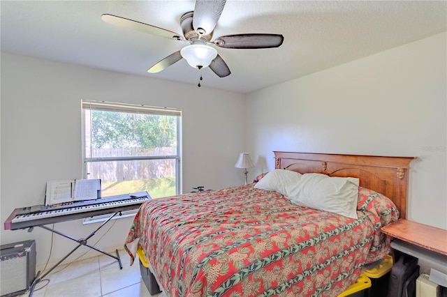 tiled bedroom featuring ceiling fan