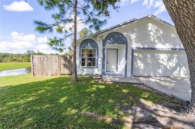 single story home featuring a front yard and a garage