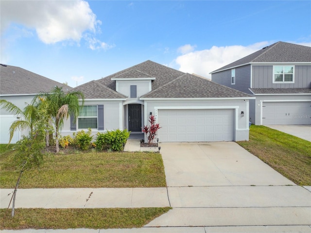 view of front of home with a front lawn and a garage