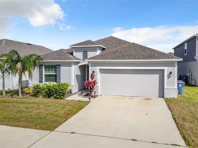 view of front of house with a front yard and a garage