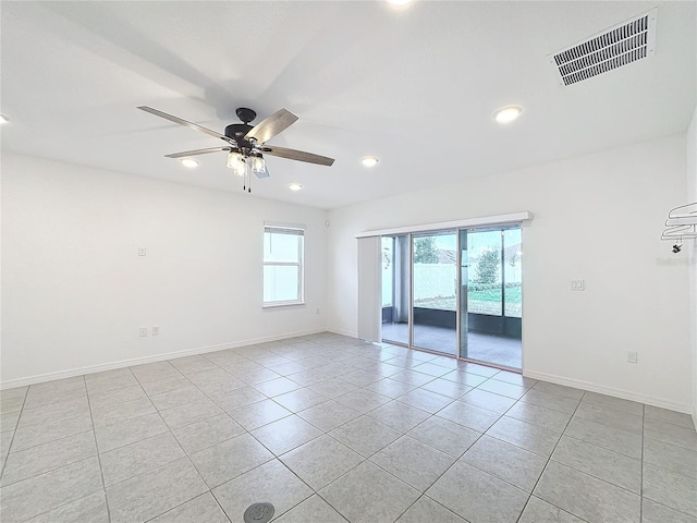 tiled spare room with ceiling fan