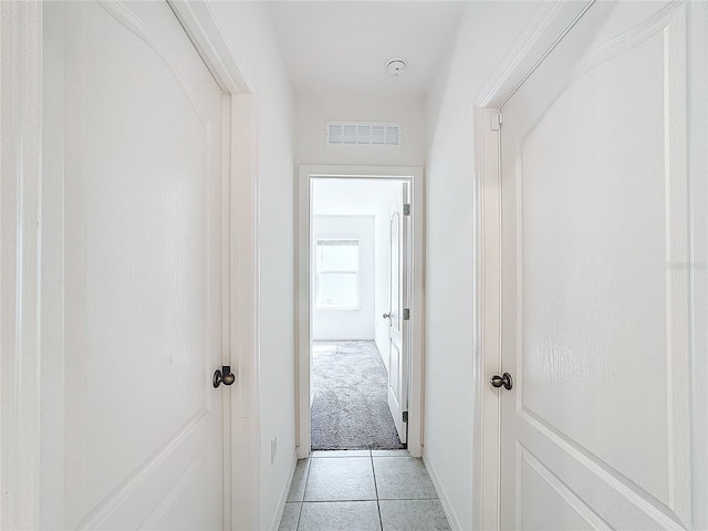 corridor with light tile patterned floors