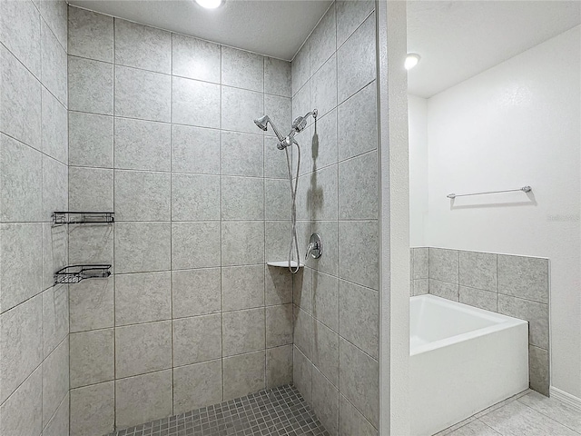 bathroom with shower with separate bathtub and tile patterned flooring