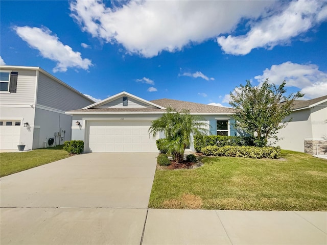 view of front of house featuring a front lawn and a garage