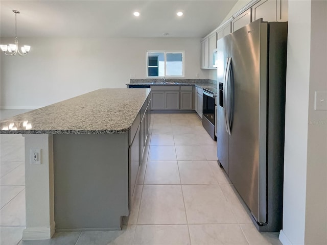 kitchen with gray cabinetry, stainless steel appliances, sink, a center island, and pendant lighting