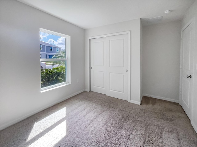 unfurnished bedroom featuring a closet and carpet floors