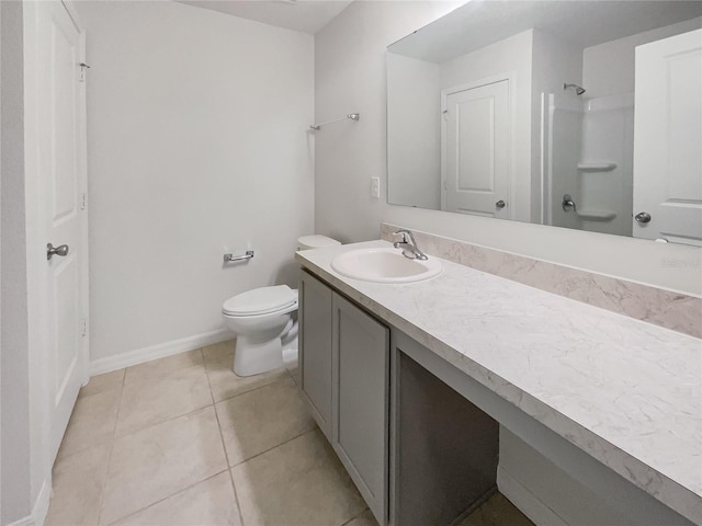 bathroom with vanity, toilet, tile patterned floors, and walk in shower