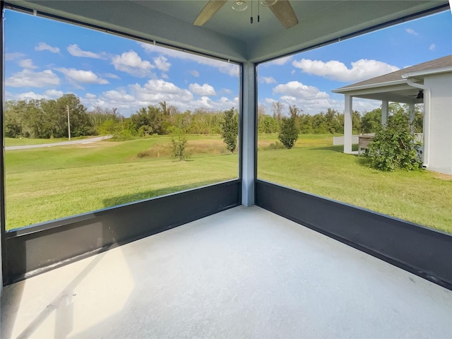 unfurnished sunroom with ceiling fan