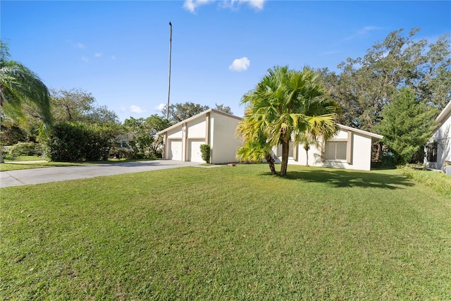 view of front of home with a front lawn and a garage