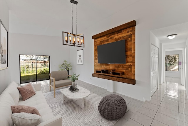 living room featuring a notable chandelier and light tile patterned floors