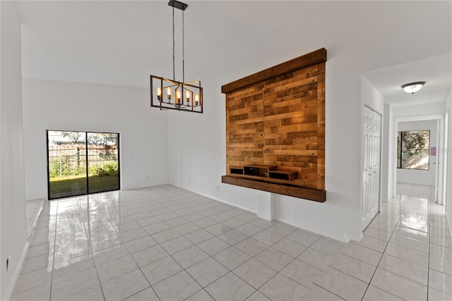 interior space featuring light tile patterned floors and an inviting chandelier