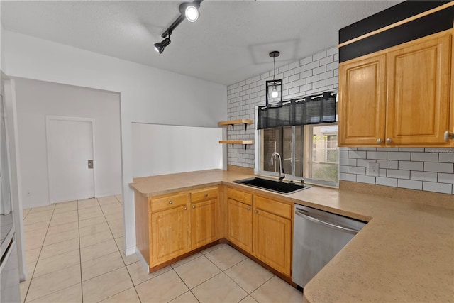 kitchen with sink, backsplash, dishwasher, and hanging light fixtures