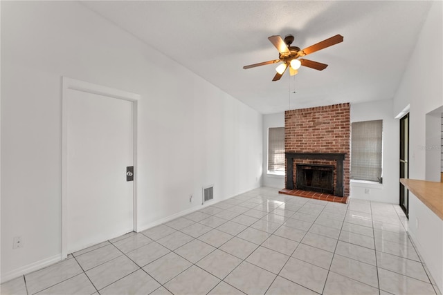 unfurnished living room featuring light tile patterned flooring, a brick fireplace, and ceiling fan