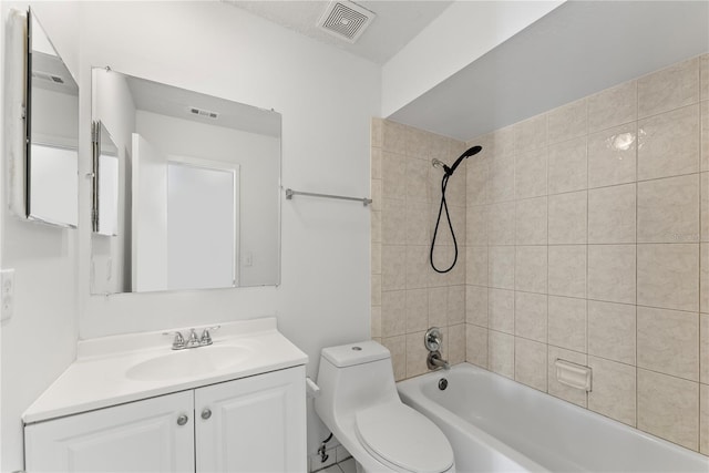 full bathroom featuring toilet, tiled shower / bath combo, and vanity