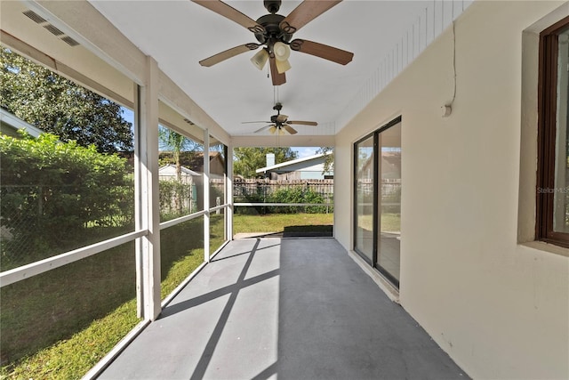 unfurnished sunroom with ceiling fan