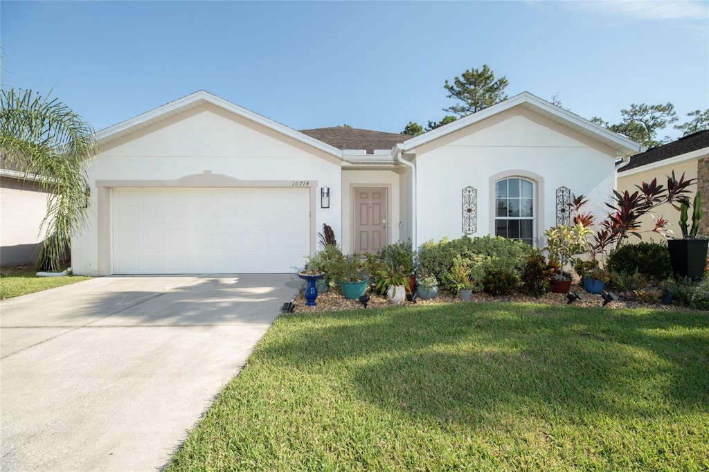 ranch-style home featuring a front lawn and a garage