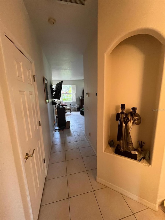2800 Tropic Ct, Winter Garden, FL 34787 - hall featuring light tile patterned flooring, baseboards, and arched walkways