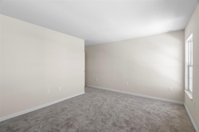 carpeted spare room with a healthy amount of sunlight