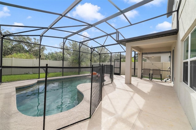 view of swimming pool featuring a patio and a lanai