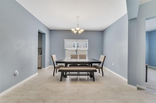 dining area featuring baseboards and a notable chandelier