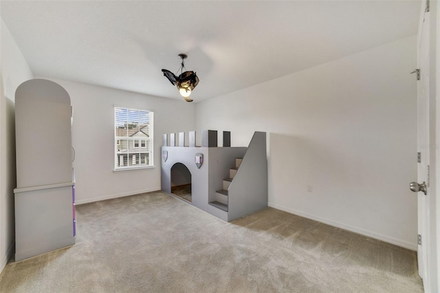 interior space with carpet floors and baseboards